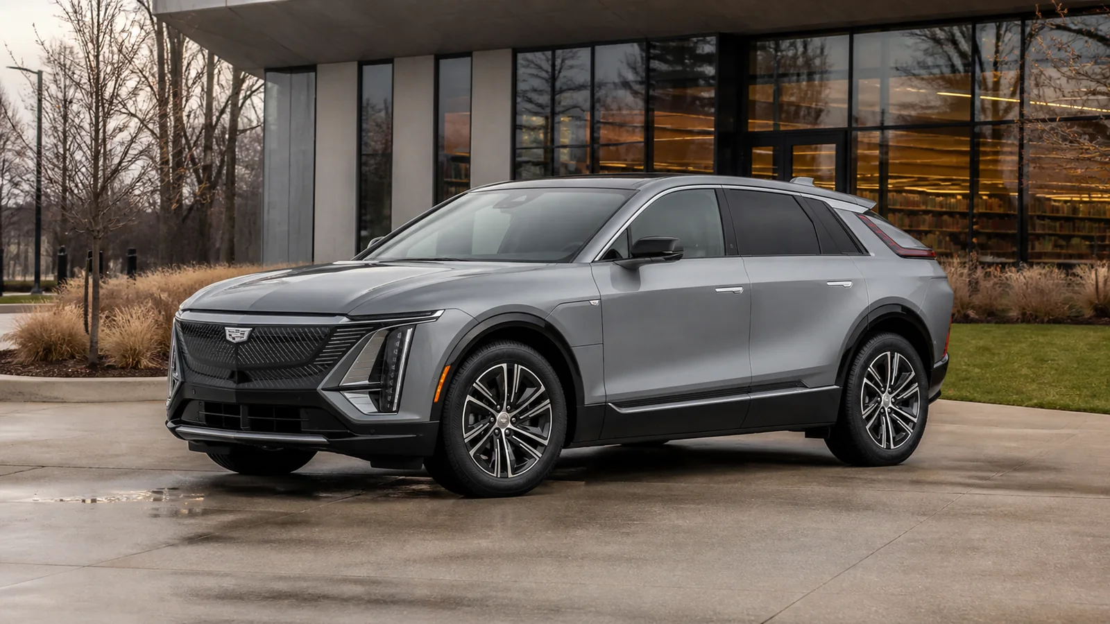 2027 Cadillac Lyriq electric SUV at a contemporary library forecourt