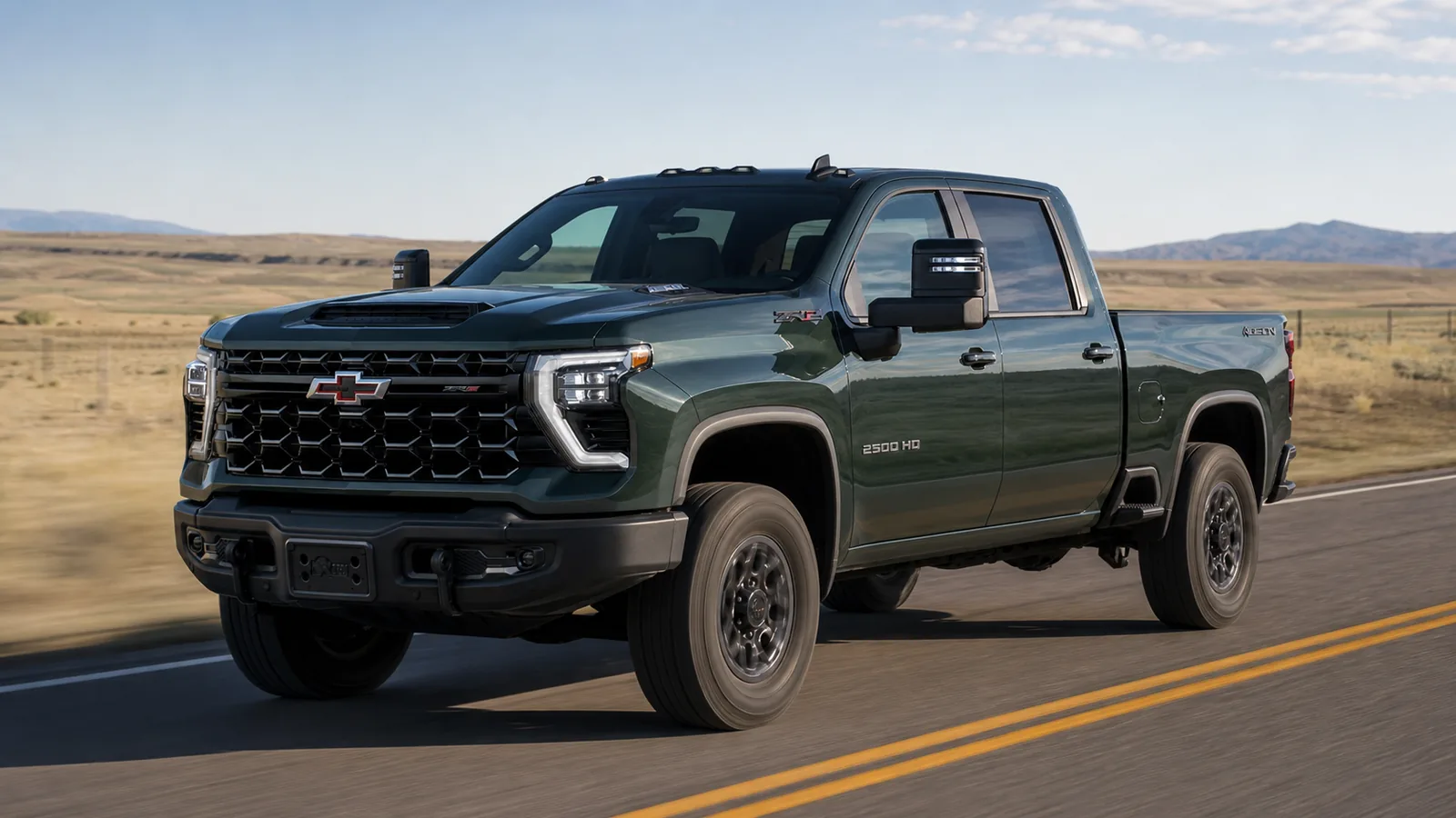2026 Chevrolet Silverado 2500 HD driving on an open high-plains highway - Chevrolet Silverado HD