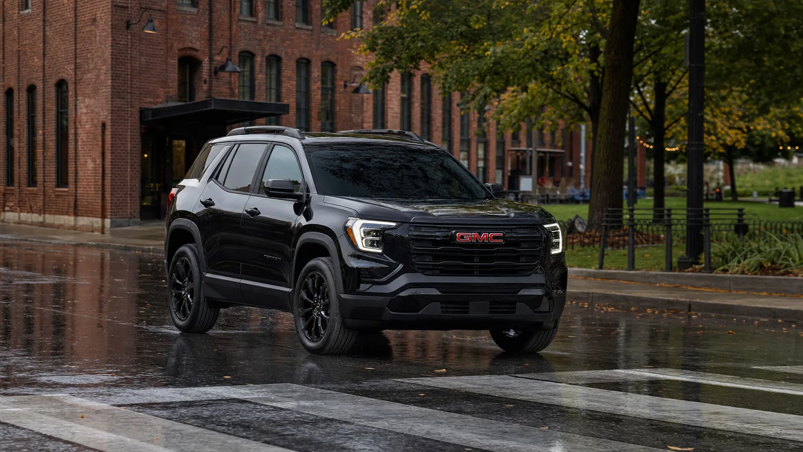 2026 GMC Terrain driving through a wet urban district - GMC Terrain