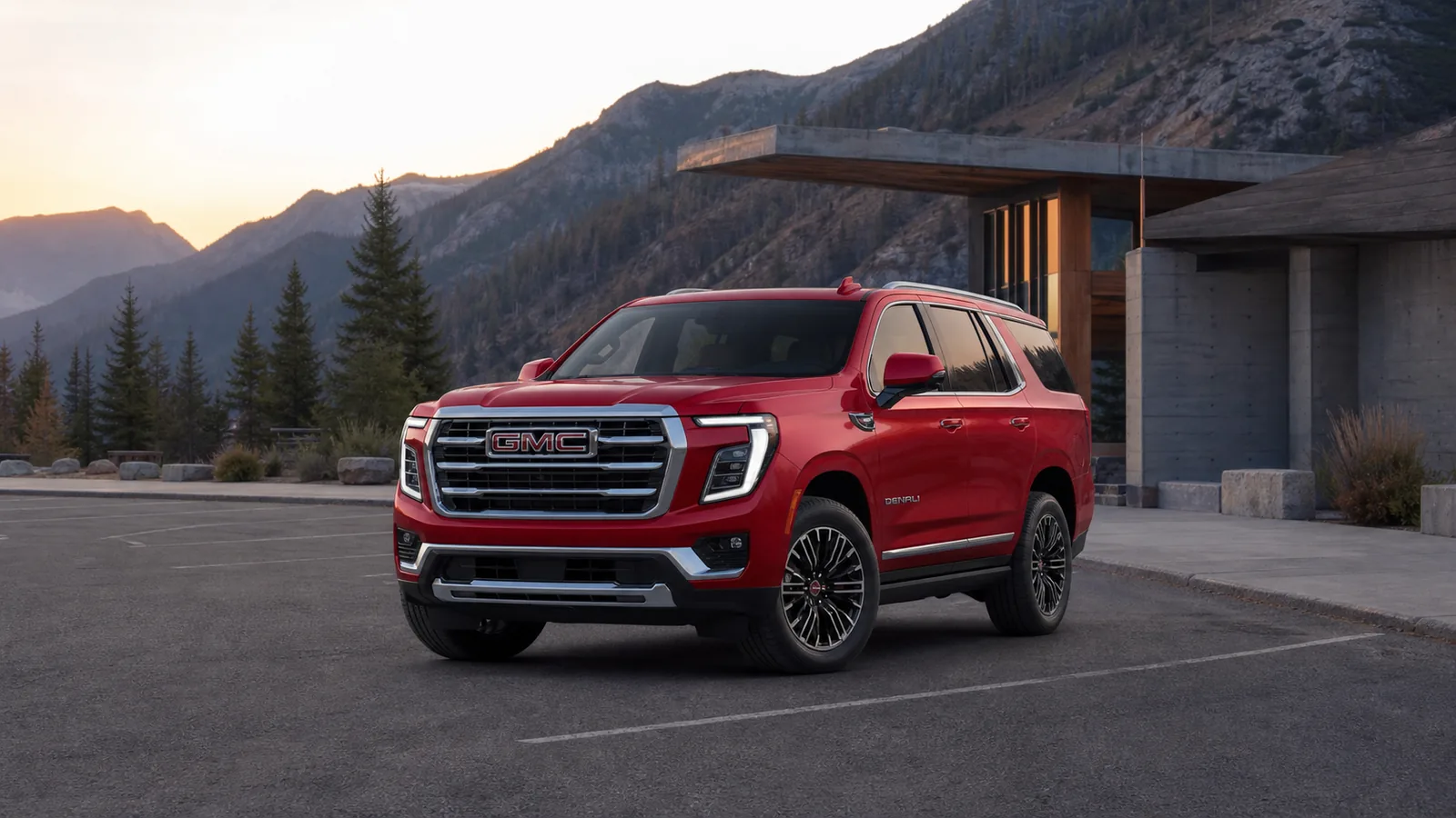 2026 GMC Yukon Denali leaving a mountain visitor center at dawn - GMC Yukon