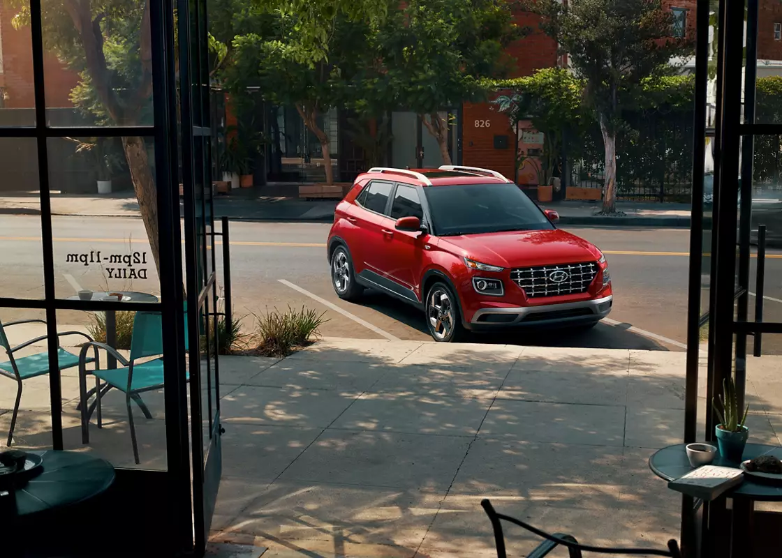 Red 2026 Hyundai Venue parked outside a city cafe - Hyundai Venue