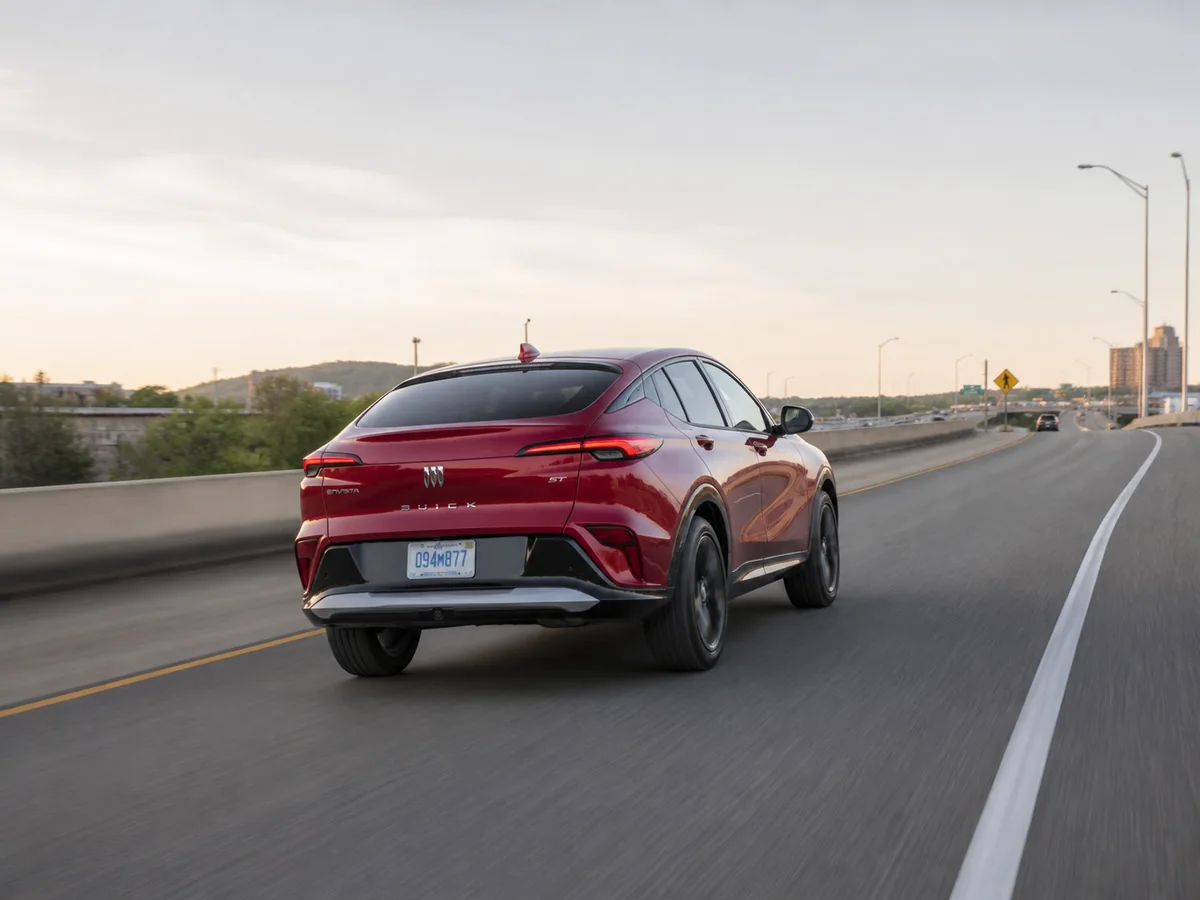 Current Buick Envista Sport Touring accelerating on an uphill suburban highway ramp - Buick Envista