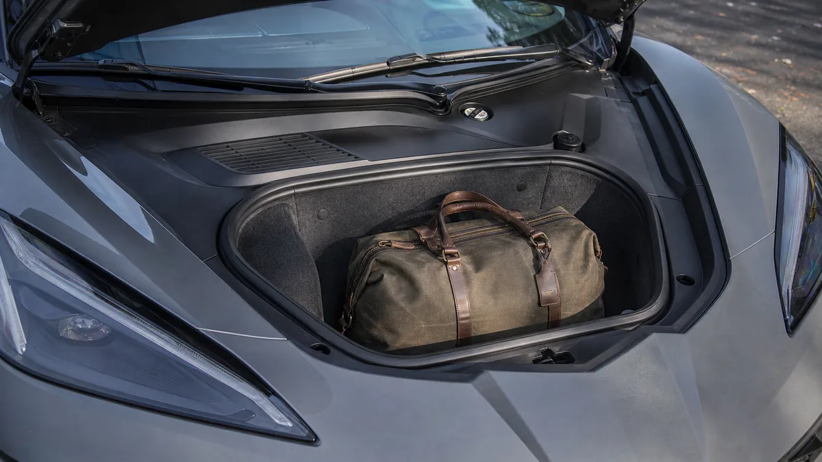 Performance coupe front cargo compartment with a weekend bag