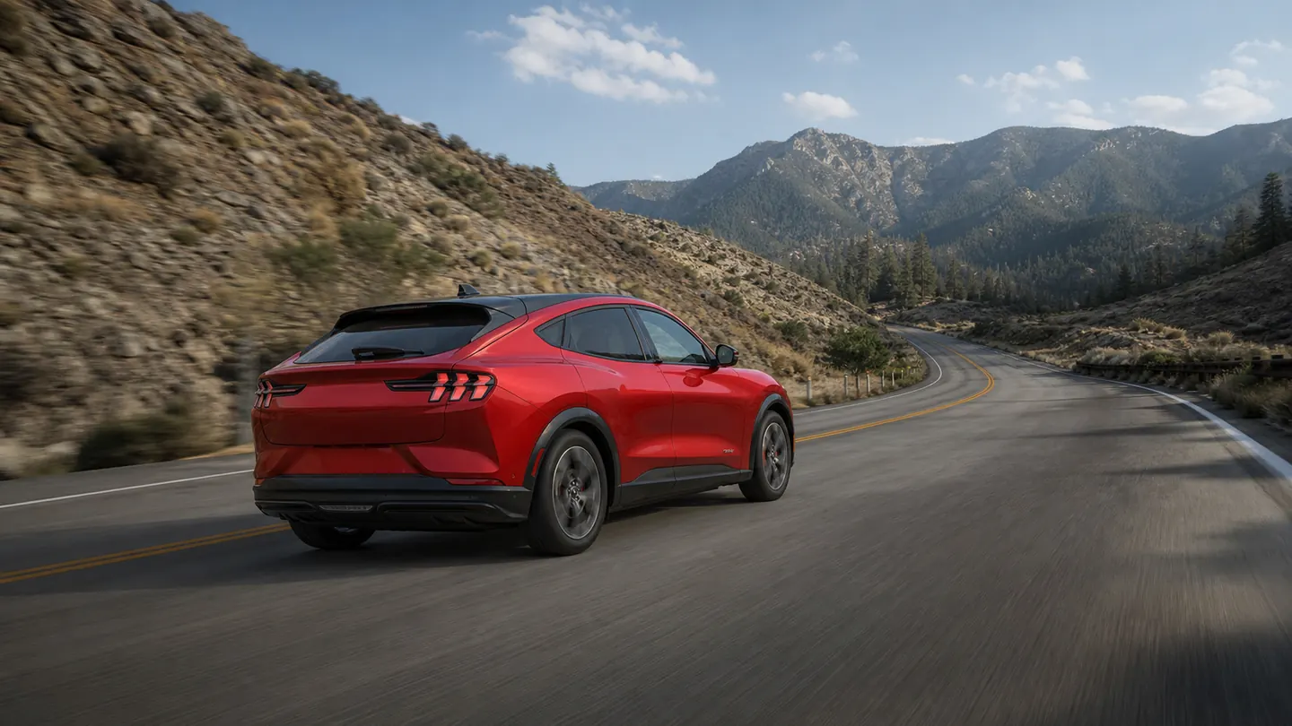 Ford Mustang Mach-E climbing a long highway grade in dry weather