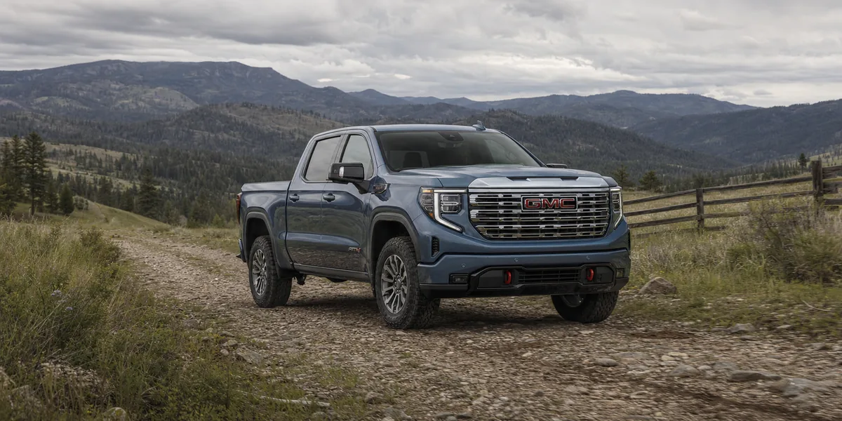 GMC Sierra 1500 AT4 on a rough access road with tire and underbody clearance visible - GMC Sierra 1500