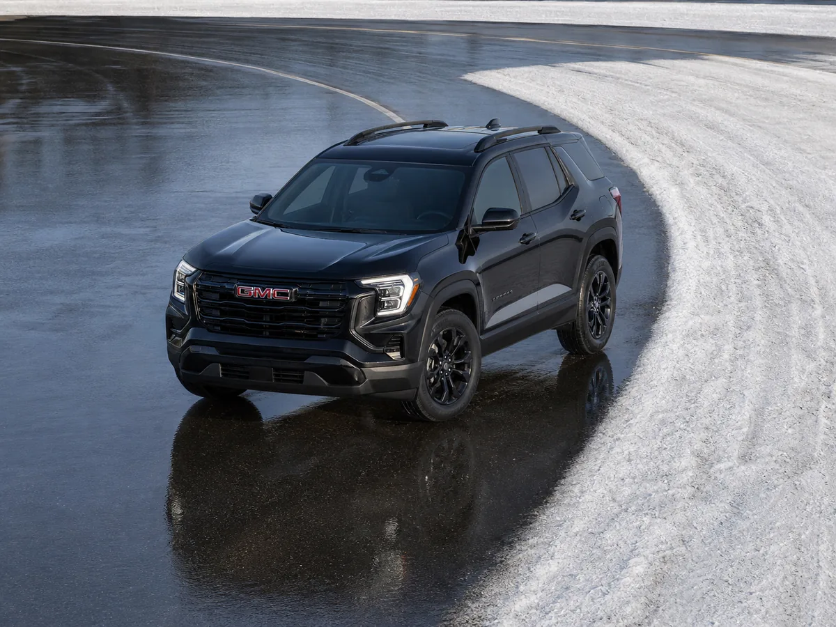 2026 GMC Terrain AWD making a slow turn across wet pavement and shallow packed snow - GMC Terrain