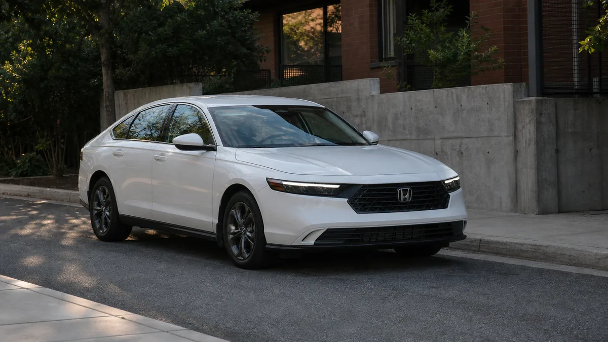 Used midsize sedan inspection in a service bay