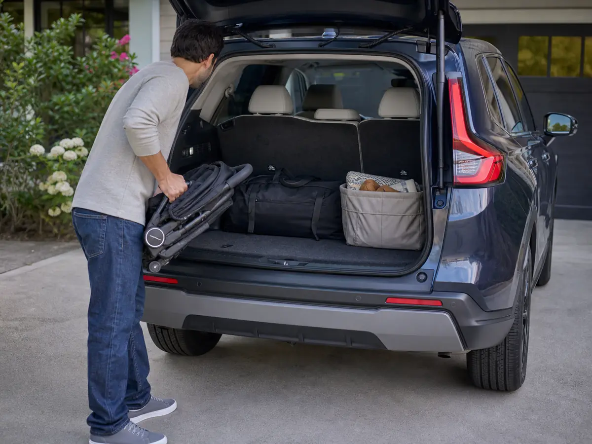 Stroller and family bags being loaded into a Honda CR-V Hybrid