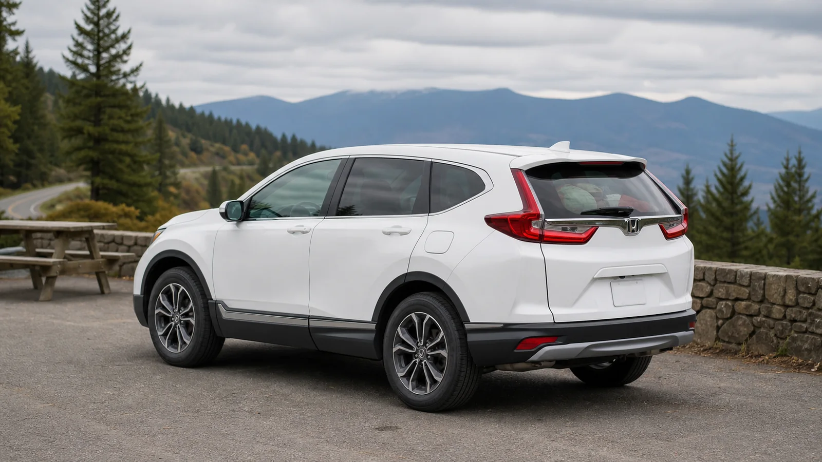 White Honda CR-V at a mountain highway rest area with luggage visible inside