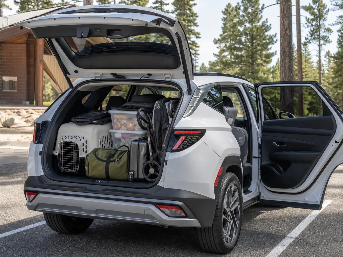 Hyundai Tucson with rear door and liftgate open, child seat installed, and normal family cargo loaded