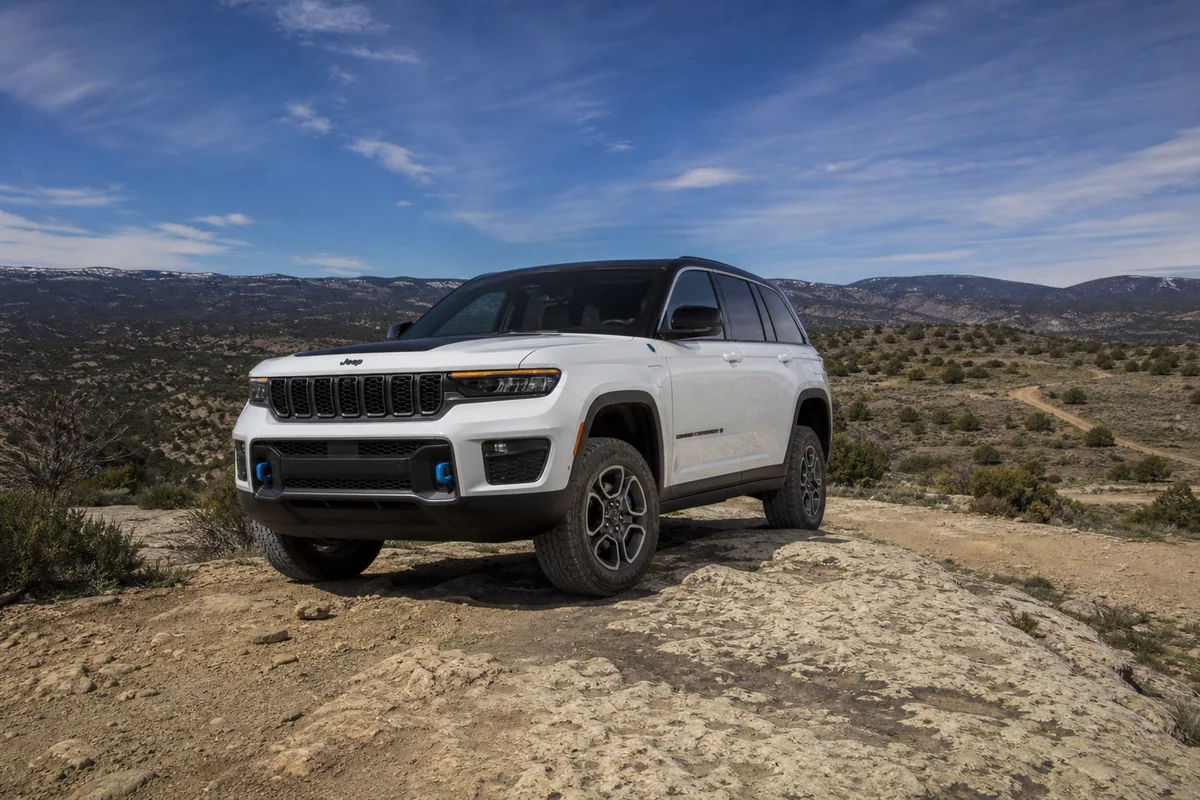 2025 Jeep Grand Cherokee 4xe Trailhawk crossing a modest dry rock shelf