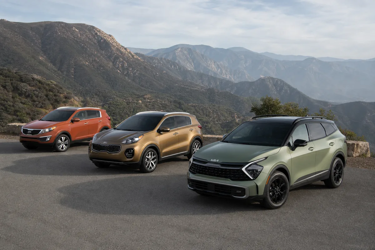 2012, 2017, and 2023 Kia Sportage generations at a mountain overlook