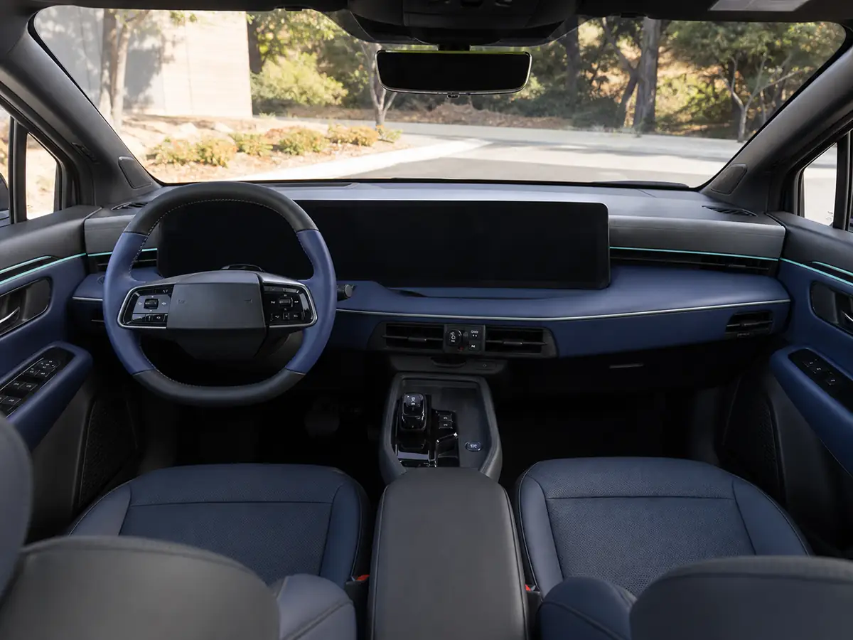 Driver view of the 2026 Nissan Leaf dashboard, steering wheel, and center controls - Nissan Leaf