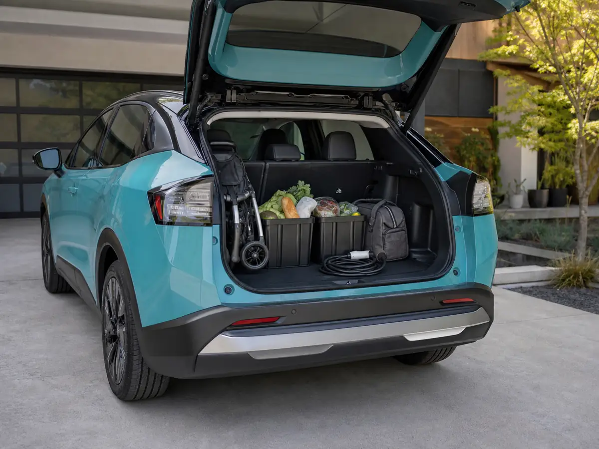 2026 Nissan Leaf cargo area loaded with a stroller, grocery bins, and charging cable - Nissan Leaf
