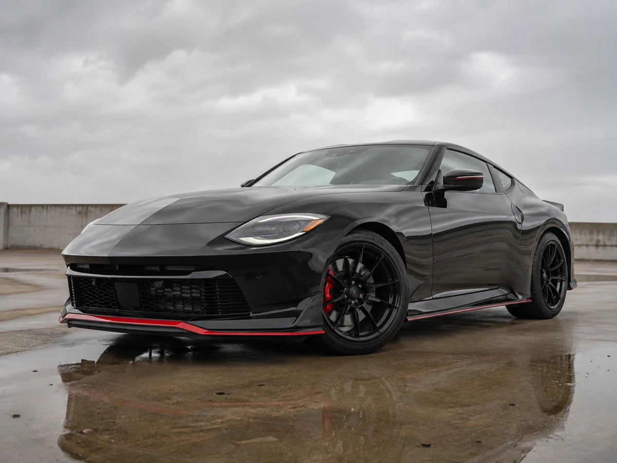 Nissan Z NISMO in front three-quarter view showing its wider body, deeper front air dam and forged wheels - Nissan Z