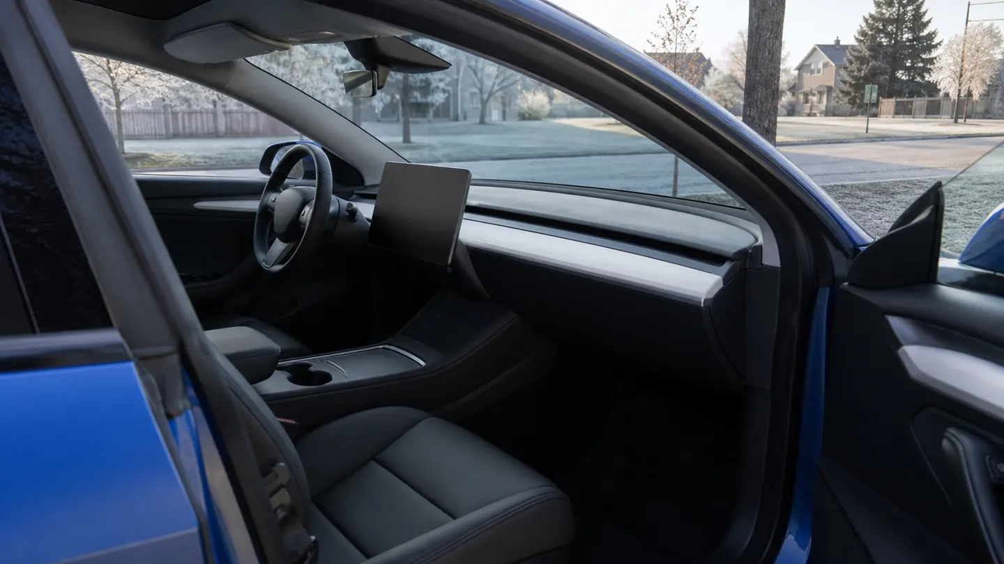 Tesla Model 3 cabin prepared for a cold morning departure with a clear windshield