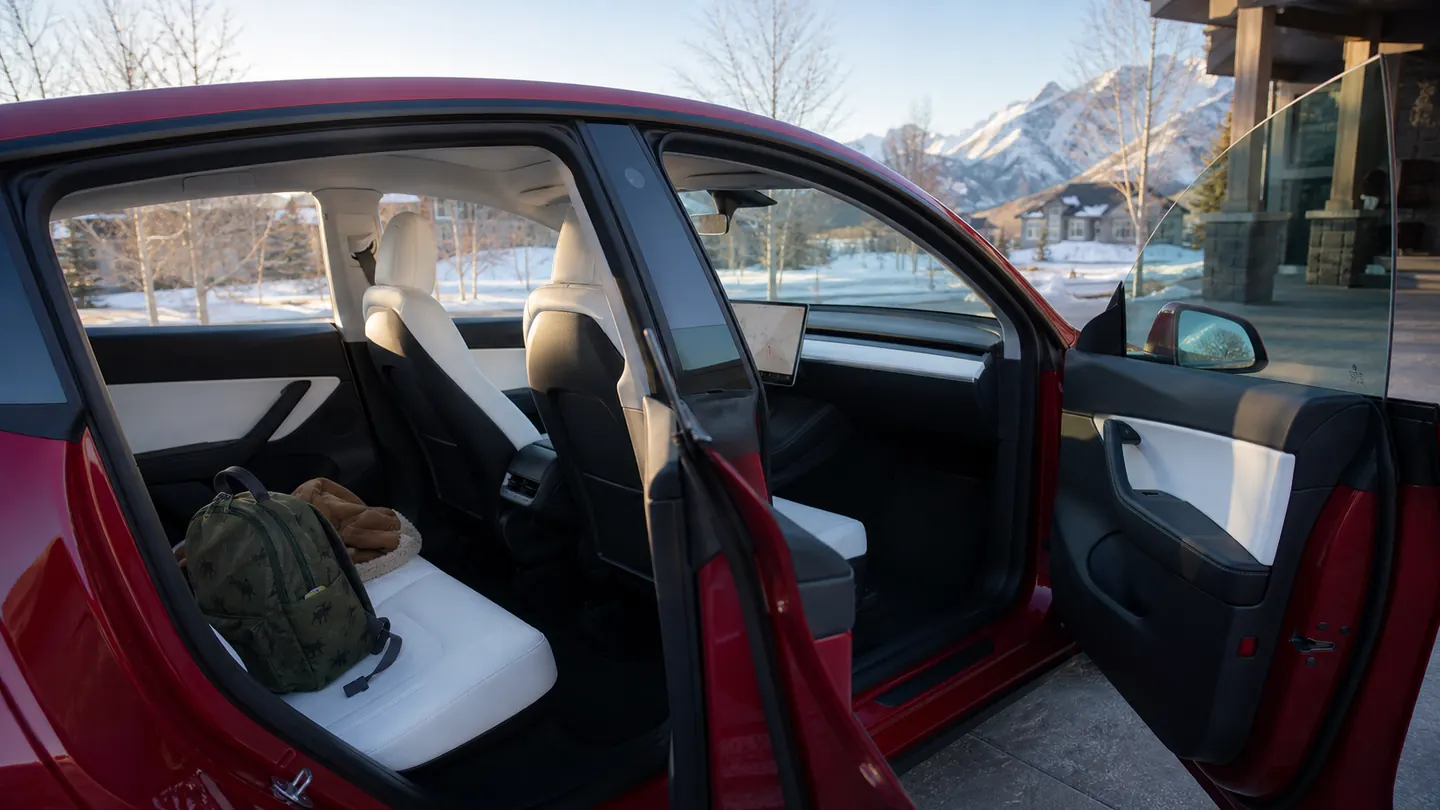 Tesla Model Y cabin prepared for a cold family departure with clear glass