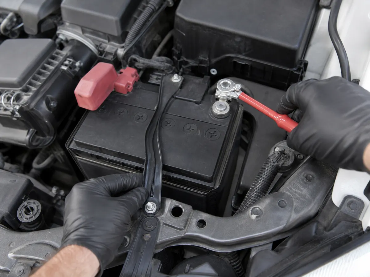 Battery hold-down, terminal clearance, and cable reach being inspected - Toyota Corolla battery fit