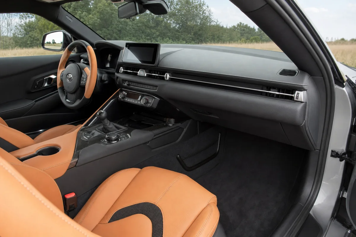2026 Toyota GR Supra cockpit with manual shifter prepared for a seating and control fit check - Toyota GR Supra
