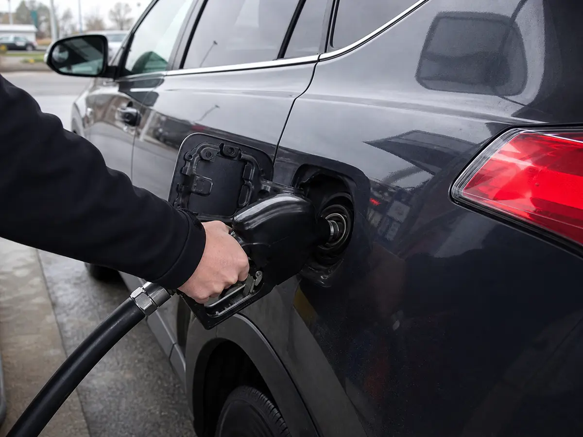 Driver checking a hybrid SUV fuel fill after the pump shuts off - Toyota RAV4 Hybrid