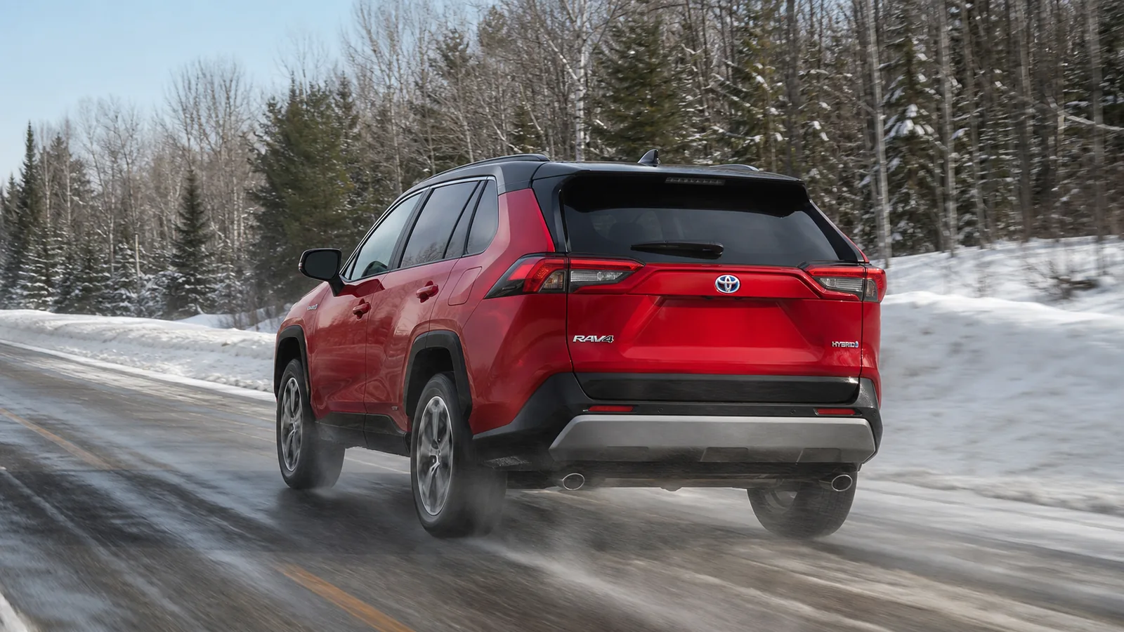 Toyota RAV4 Hybrid driving on a wet salted winter road